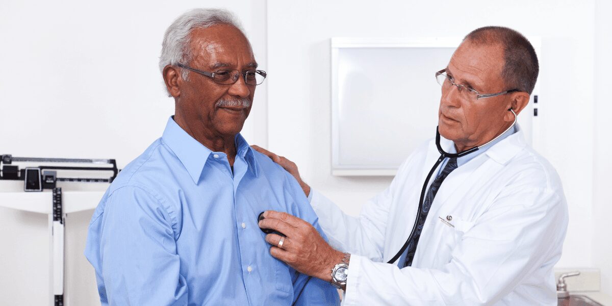 Men'sHealthMonth1_1200x600 Doctor listening to the heart of a middle aged Black man