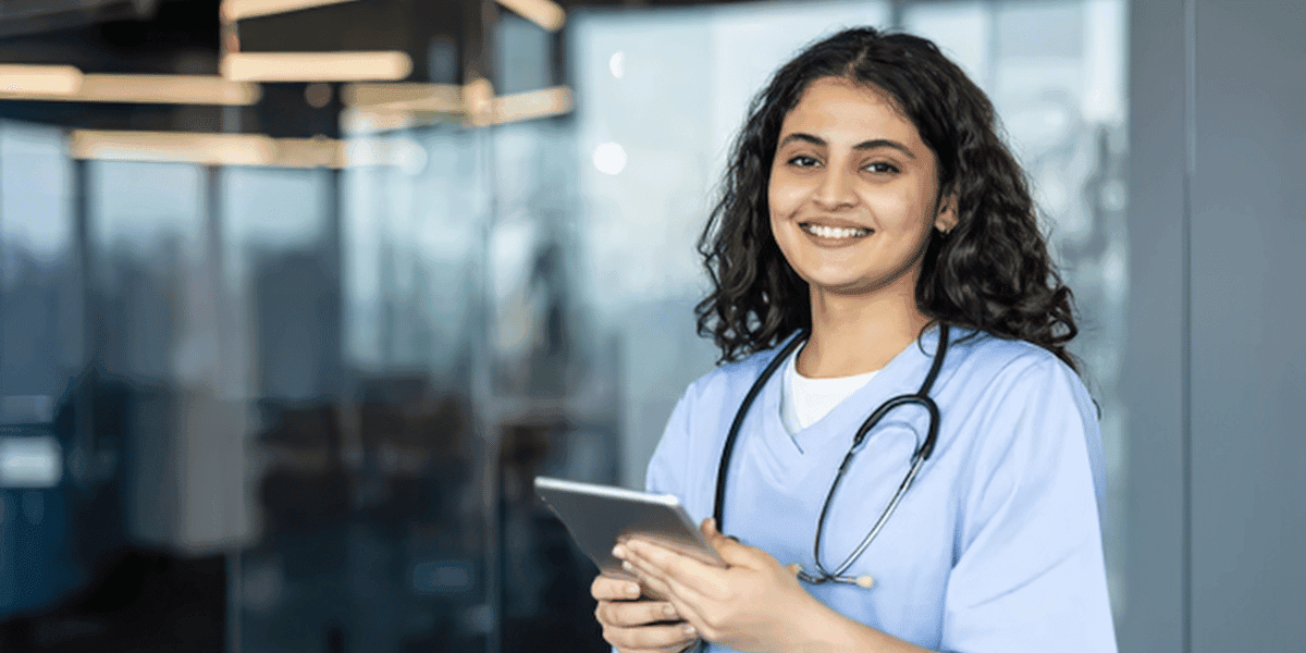 AI inhealthcare_1200x600 Smiling Female Healthcare Worker with Tablet
